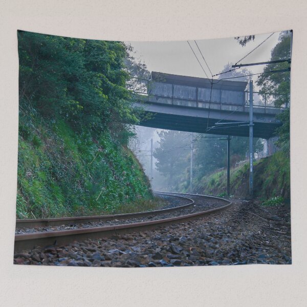 Item preview, Lonely train tracks disappearing under a bridge and into a foggy morning landscape designed and sold by James-Cole.