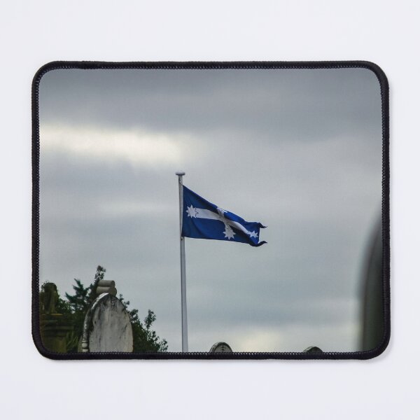 Item preview, Eureka flag flying in the wind on a gloomy overcast day in the old Ballarat cemetery designed and sold by James-Cole.