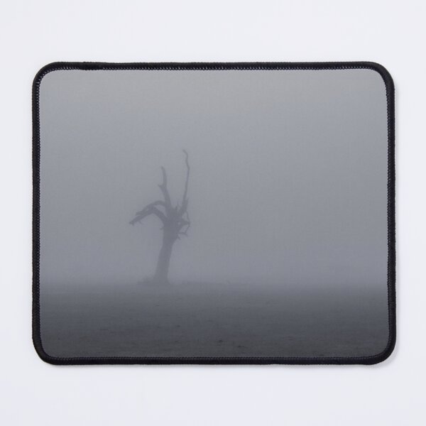 Item preview, Creepy silhouette of dead tree stump stands alone in a foggy field designed and sold by James-Cole.