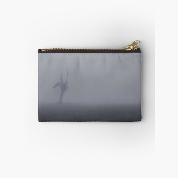 Item preview, Creepy silhouette of dead tree stump stands alone in a foggy field designed and sold by James-Cole.