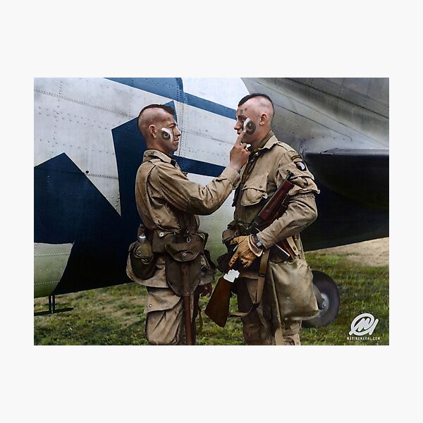 Filthy Thirteen member Clarence Ware applies war paint to Charles Plaudo. England, 31 December 1943. Photographic Print