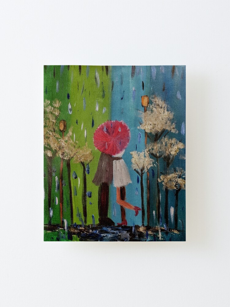 Alternate view of A couple having a kiss in the rain under the umbrella in a park Mounted Print