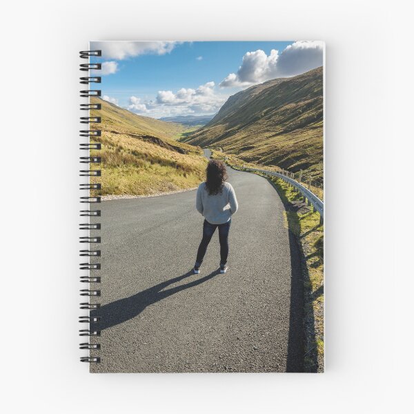 Item preview, A young beautiful woman with long curly hair stands on the highway of the Glengesh Pass between the mountains in Ardara, County Donegal, Ireland designed and sold by AlbertMi.