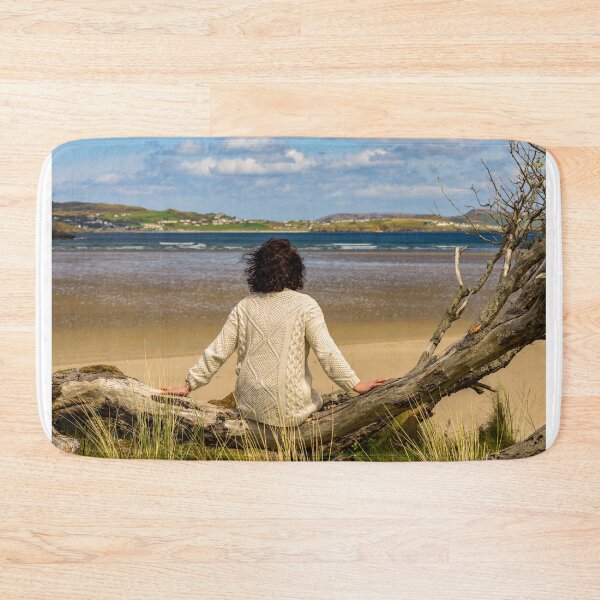 Item preview, A woman rests on the shore and enjoys views of the Atlantic Ocean in Ireland designed and sold by AlbertMi.
