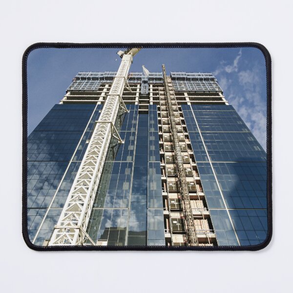 Item preview, A new high-rise under construction reflecting blue skies and fluffy clouds in the glass windows designed and sold by James-Cole.