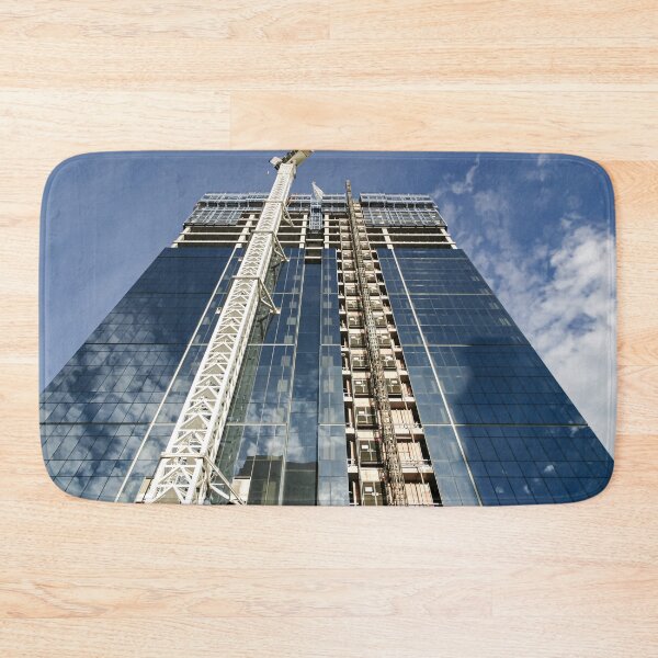 Item preview, A new high-rise under construction reflecting blue skies and fluffy clouds in the glass windows designed and sold by James-Cole.