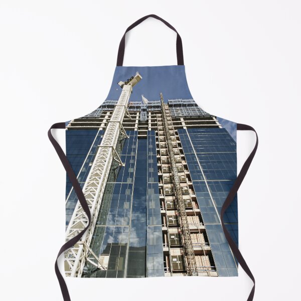 Item preview, A new high-rise under construction reflecting blue skies and fluffy clouds in the glass windows designed and sold by James-Cole.