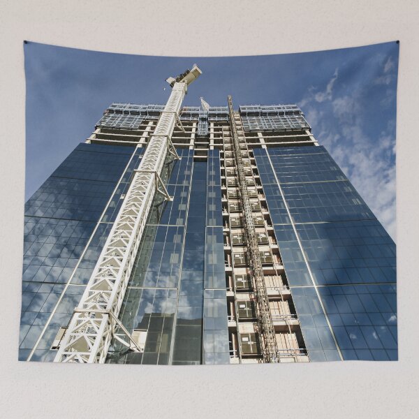 Item preview, A new high-rise under construction reflecting blue skies and fluffy clouds in the glass windows designed and sold by James-Cole.