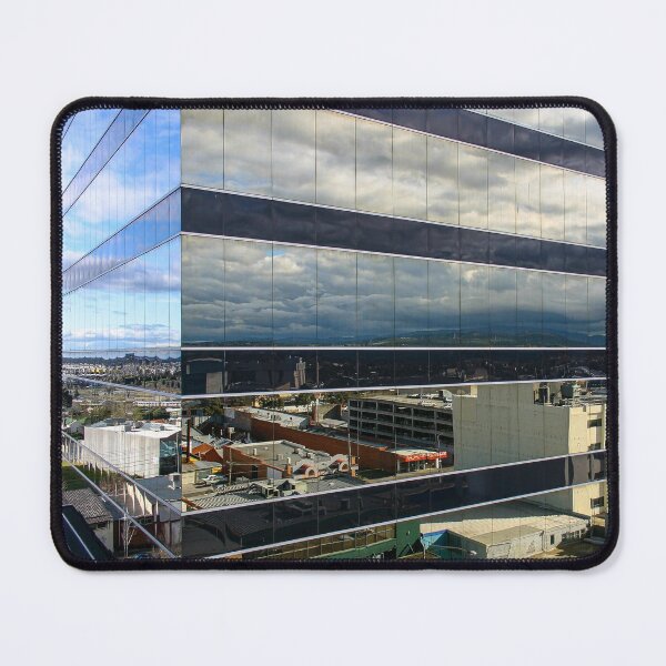 Item preview, A cloudy sky reflected on the corner of a glass high-rise building designed and sold by James-Cole.