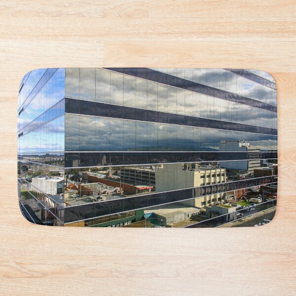 Item preview, A cloudy sky reflected on the corner of a glass high-rise building designed and sold by James-Cole.