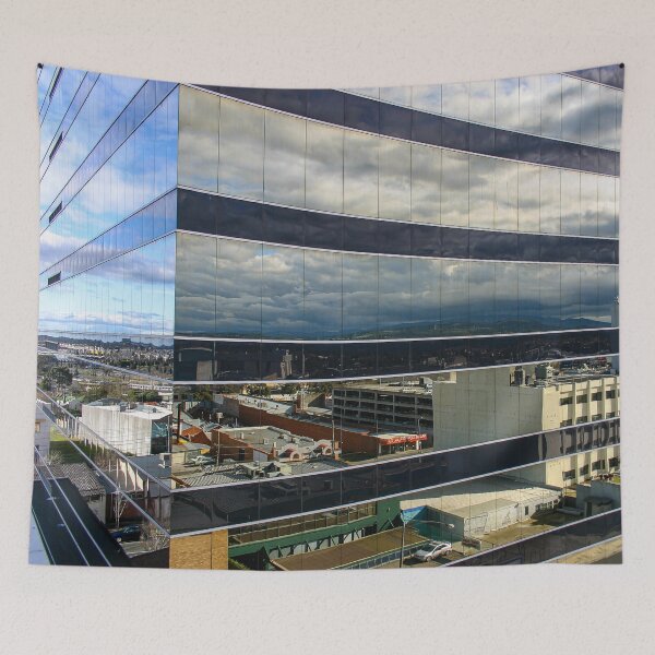Item preview, A cloudy sky reflected on the corner of a glass high-rise building designed and sold by James-Cole.