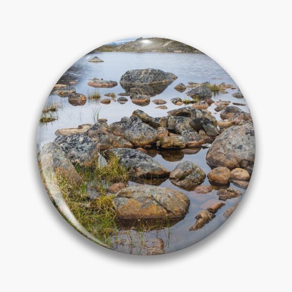 Item preview, Nunavut landscape - rocks next to a small lake with mountains at the background  designed and sold by VadimK.
