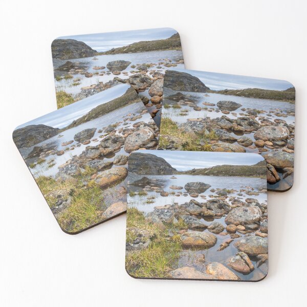 Item preview, Nunavut landscape - rocks next to a small lake with mountains at the background  designed and sold by VadimK.