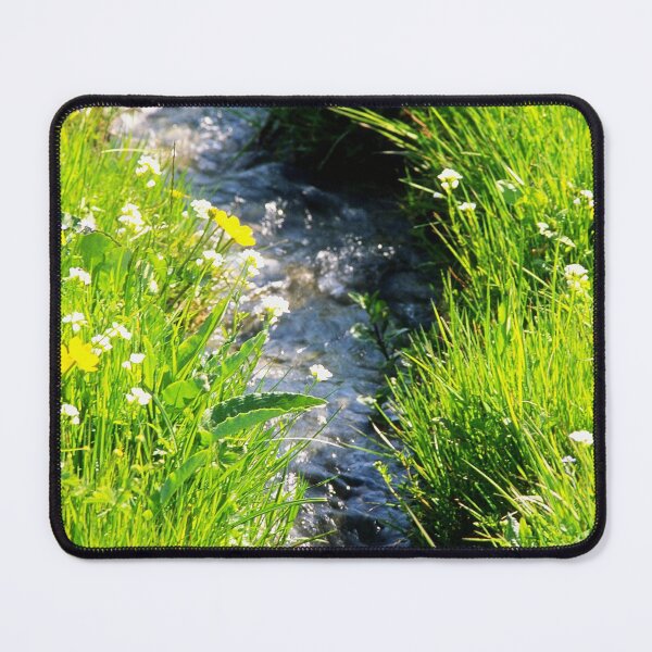 Item preview, Gently babbling brook meandering through a bright green field with summer wild flowers. Close up. designed and sold by JellyBeenzz.