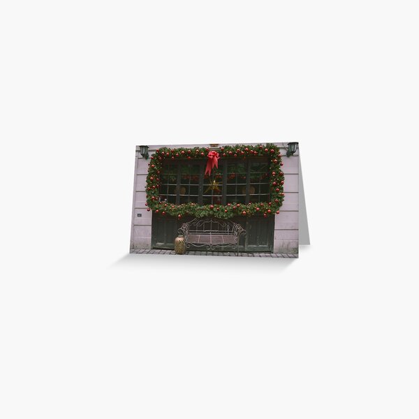 Iron bench with Christmas frame on window Greeting Card