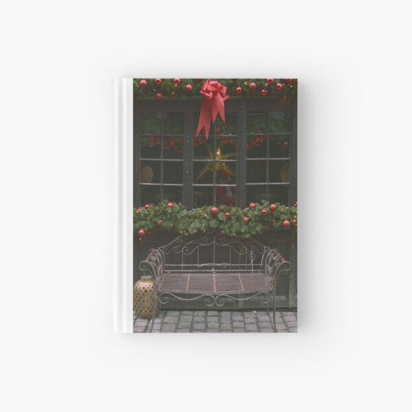 Iron bench with Christmas frame on window Hardcover Journal