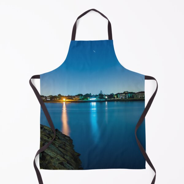Item preview, Long exposure of coastal town at night with lights reflecting in the blurry water designed and sold by James-Cole.