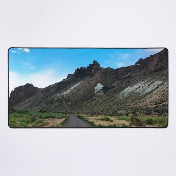 Adventure Amidst Rugged Crags and Azure Hues Desk Mat
