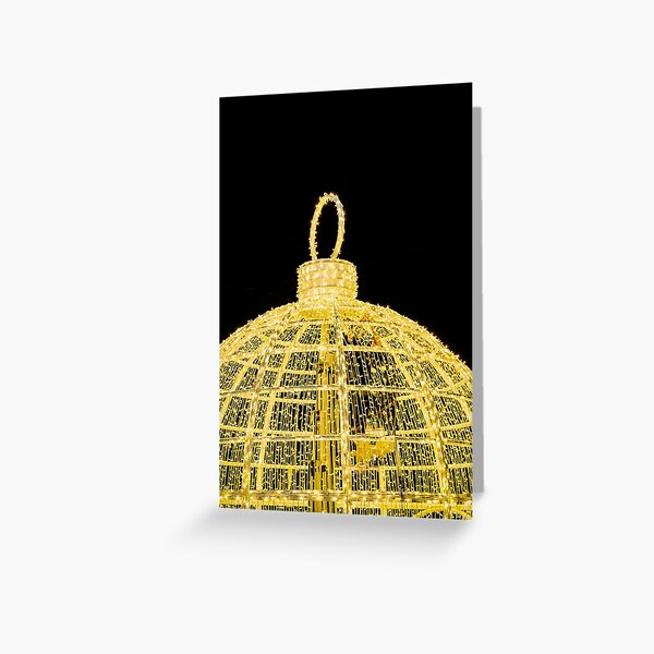Gold Christmas Ball with lights on black background Greeting Card