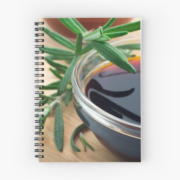 Item preview, Glass cup with soy sauce and rosemary leaves closeup designed and sold by vladromensky.