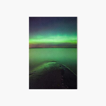 Northern lights glow over lake Art Board Print