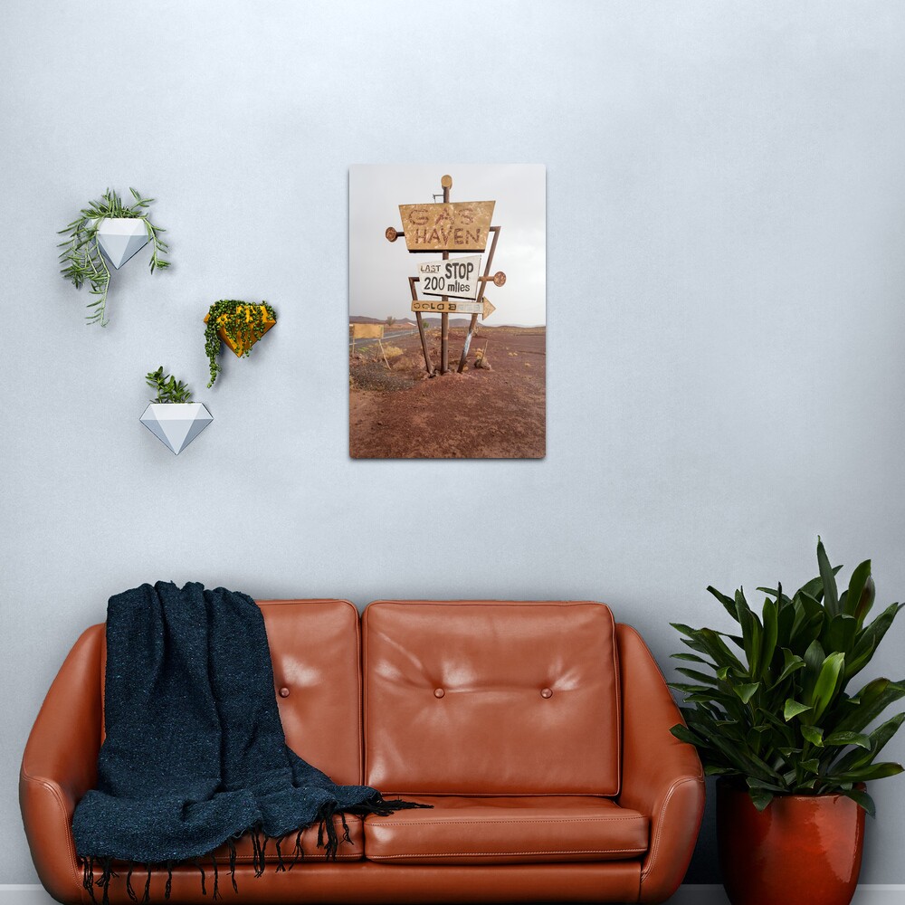 Tall vintage gas sign standing in the desert Metal Print