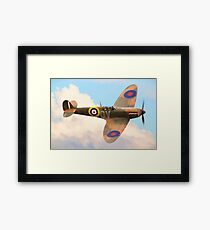 Spitfire in the clouds Framed Print