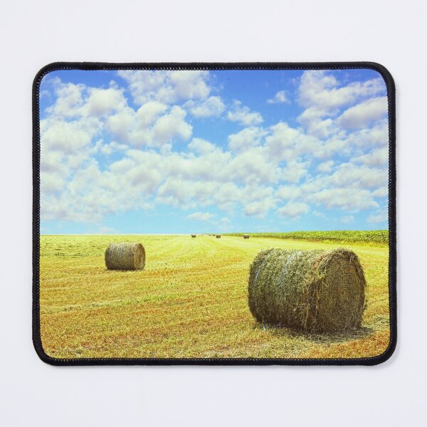 Item preview, Golden stubble field and hay bales against blue cloudy sky. designed and sold by IaroslavB.
