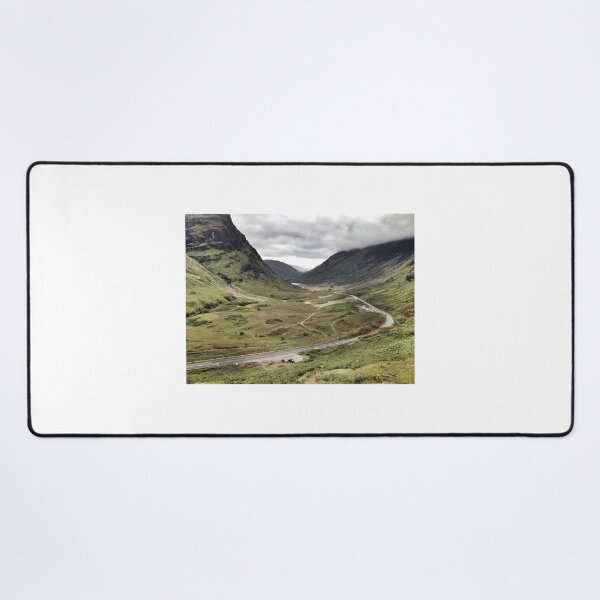 The A82 road sweeps through Glencoe, Highlands of Scotland Desk Mat