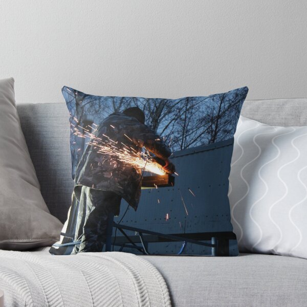 Item preview, worker cuts metal, sheaf of bright sparks scatter in the twilight  designed and sold by mrivserg.
