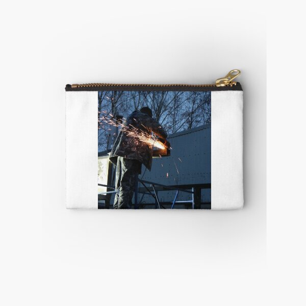 Item preview, worker cuts metal, sheaf of bright sparks scatter in the twilight  designed and sold by mrivserg.