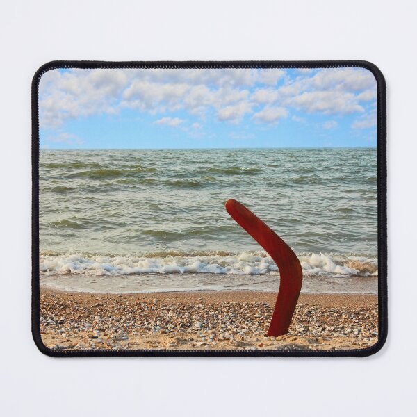 Item preview, Australian Boomerang on sandy beach against of sea surf and sky. designed and sold by IaroslavB.