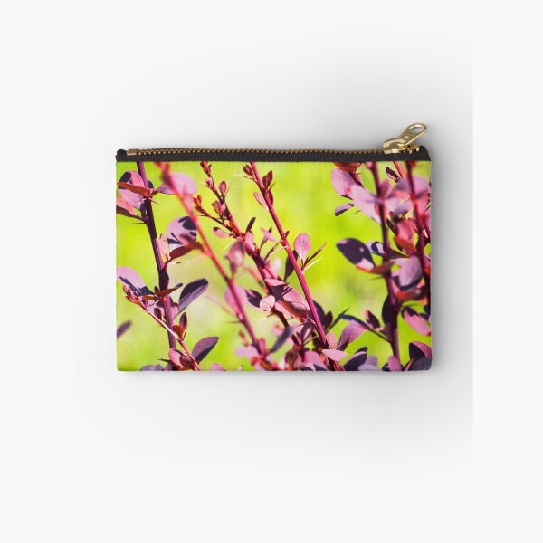 Item preview, Extremely green nature background. Red leaves of Berberis. Spring photo designed and sold by aquapixel.