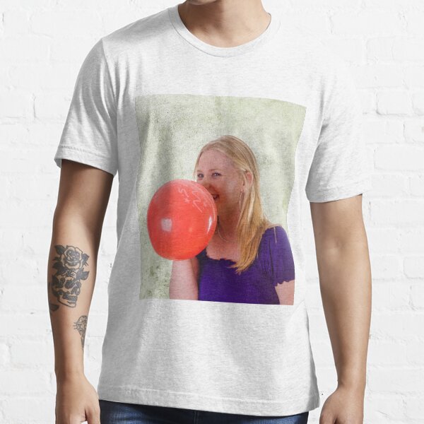 Young woman blowing red balloon