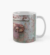 Detail of old wooden door with rusty padlock Mug