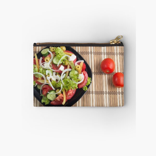 Item preview, Aerial view of one portion of vegetable salad on a plate of black and striped mat designed and sold by vladromensky.