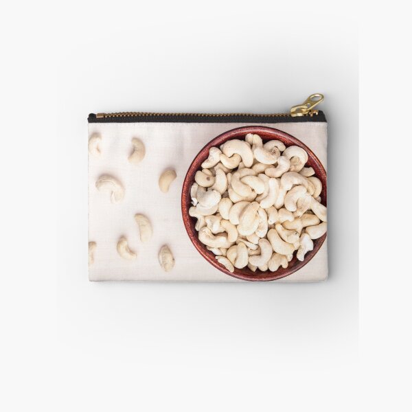 Item preview, Top view on raw cashew nuts for vegetarian food in a small wooden bowl designed and sold by vladromensky.