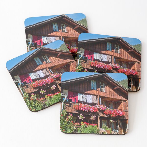 Item preview, Red geraniums and laundry in an old wooden farmhouse in Grindelwald designed and sold by Michael Brewer.