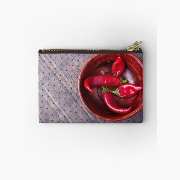 Item preview, Top view of hot red chili peppers in a brown wooden bowl designed and sold by vladromensky.