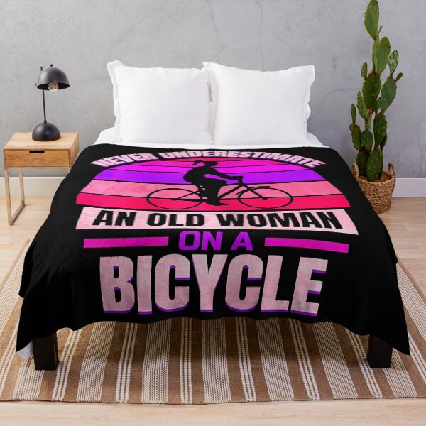 Item preview, Never Underestimate an Old Woman On A Bicycle designed and sold by spherevilla.