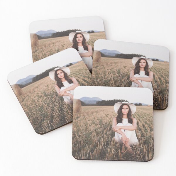 Item preview, A girl in white clothes and a hat sits in a field of mown grass designed and sold by Evgeniia Biriukova.
