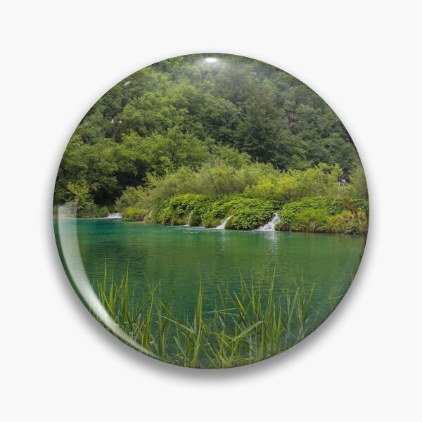 Item preview, A view of a green lake over reeds with a waterfall in the background, Plitvice Lakes, Croatia designed and sold by SnapTPhotograph.