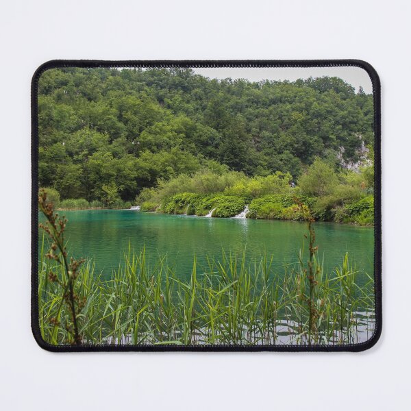Item preview, A view of a green lake over reeds with a waterfall in the background, Plitvice Lakes, Croatia designed and sold by SnapTPhotograph.