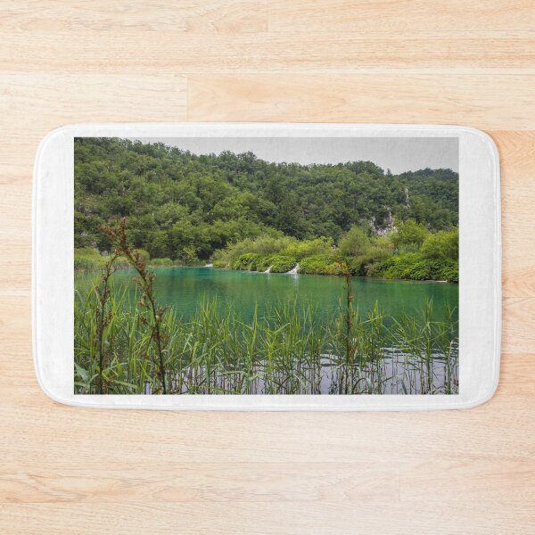 Item preview, A view of a green lake over reeds with a waterfall in the background, Plitvice Lakes, Croatia designed and sold by SnapTPhotograph.