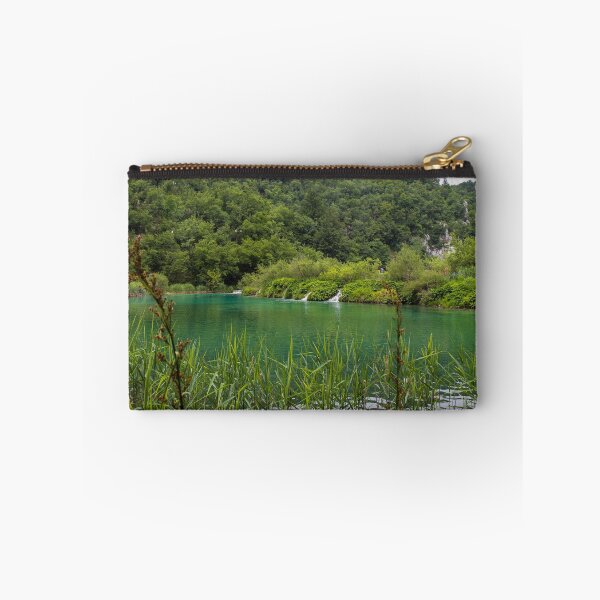 Item preview, A view of a green lake over reeds with a waterfall in the background, Plitvice Lakes, Croatia designed and sold by SnapTPhotograph.