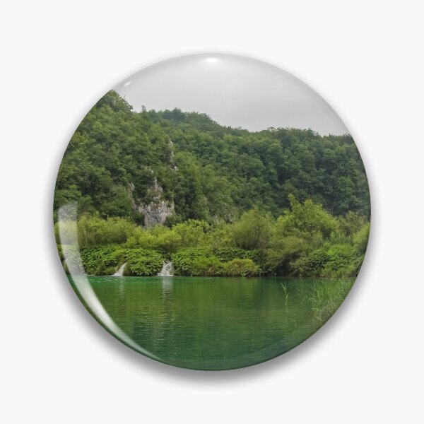 Item preview, A view of a green lake over reeds with a waterfall and mountain in the background, Plitvice Lakes, Croatia designed and sold by SnapTPhotograph.