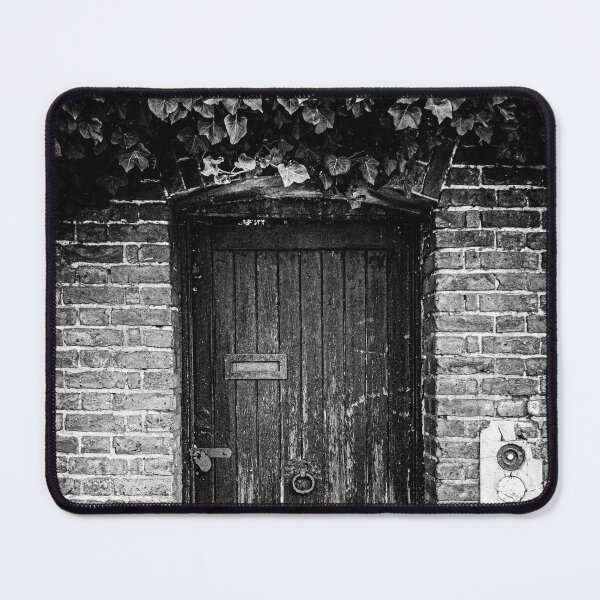 Item preview, Black and white photo of a closed weathered door to a secret garden in London designed and sold by Diana van Neck.