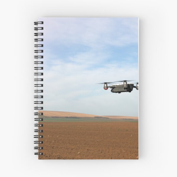 Item preview, The drone is flying over the plowed field in springtime designed and sold by goceris.