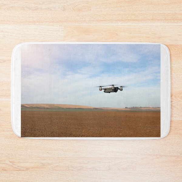 Item preview, The drone is flying over the plowed field in springtime designed and sold by goceris.