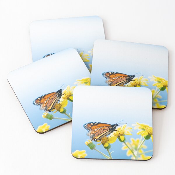 Item preview, Monarch butterfly resting on yellow daisy against sky background. designed and sold by Brian Scantlebury.